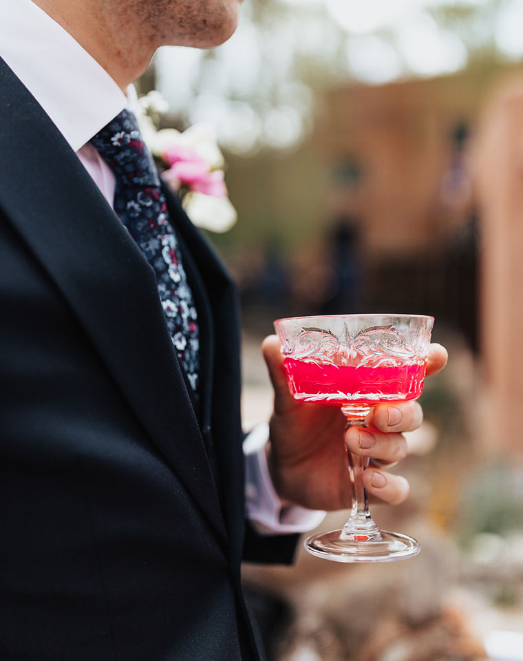 groom holding cocktail