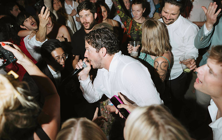 groom singing at wedding reception