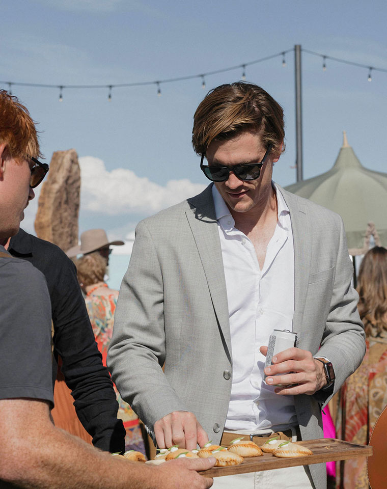 wedding guest sampling hors d'oeuvres